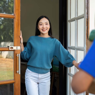 Woman opening door to visitor